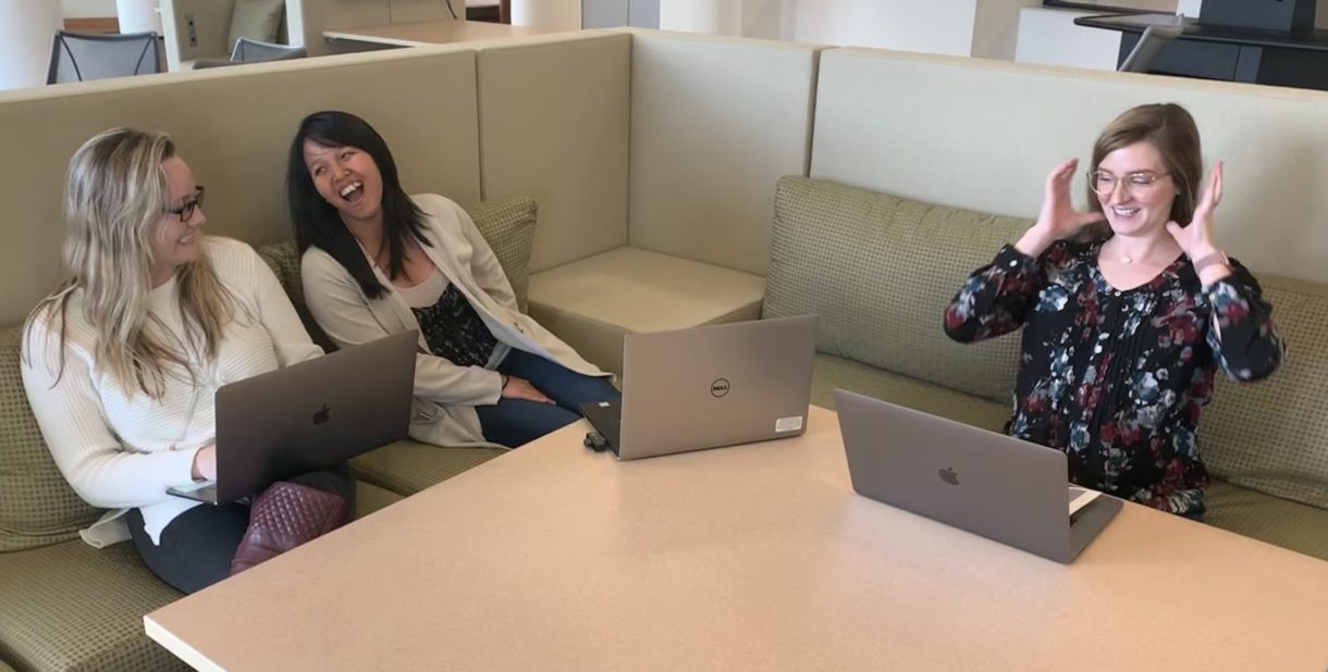 Women working on laptops and laughing 
